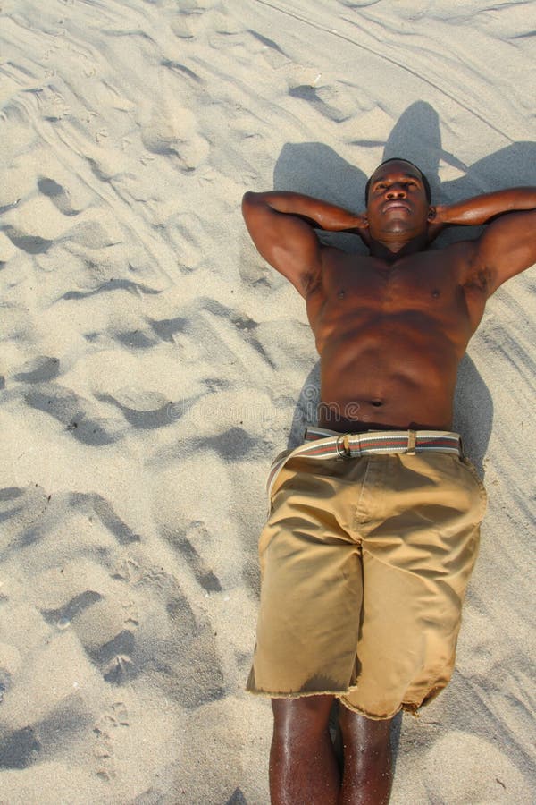 Man Laying On The Sand