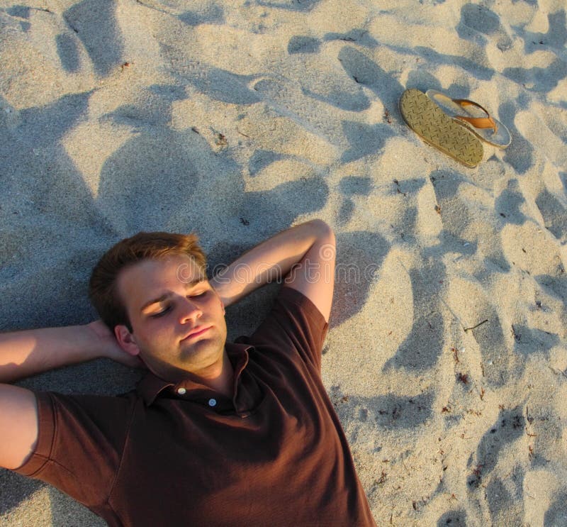 Man Laying On Sand