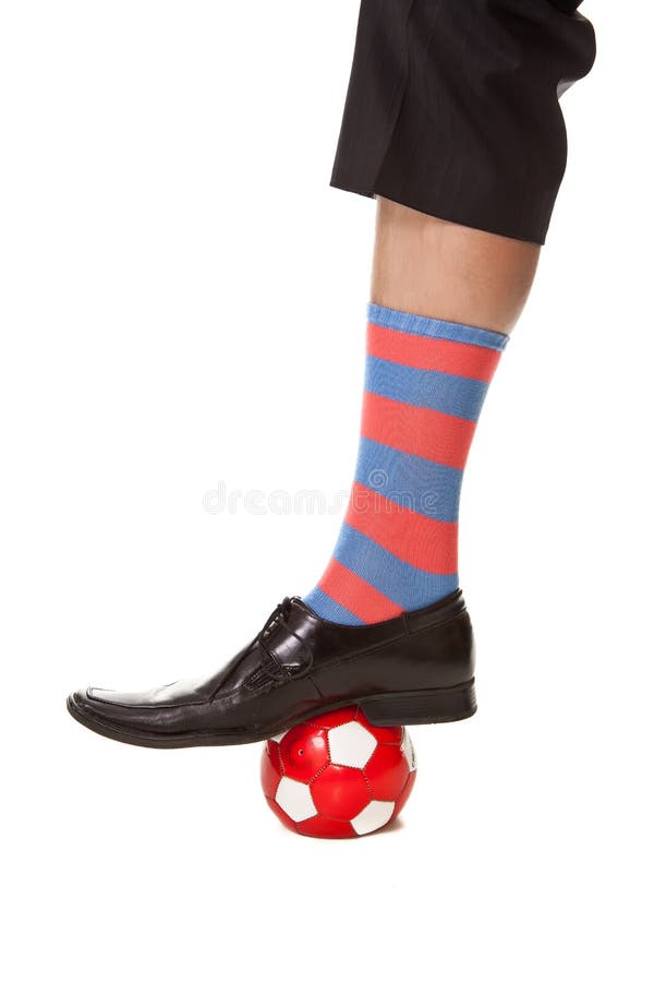 Man leg in suit with soccer ball