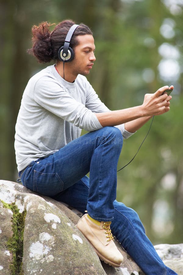 Man Listening To MP3 Player Whilst Hiking