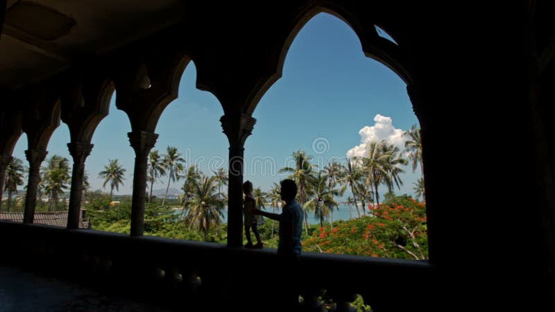 Man Little Girl Silhouettes in Gallery Arch of Gothic Building