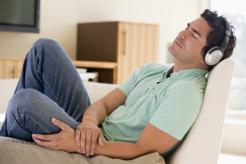 Man in living room listening to headphones