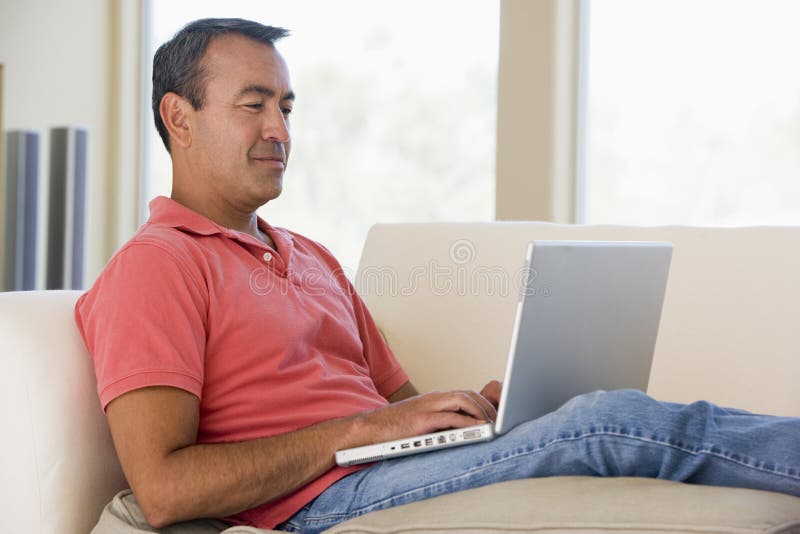 Man in living room using laptop