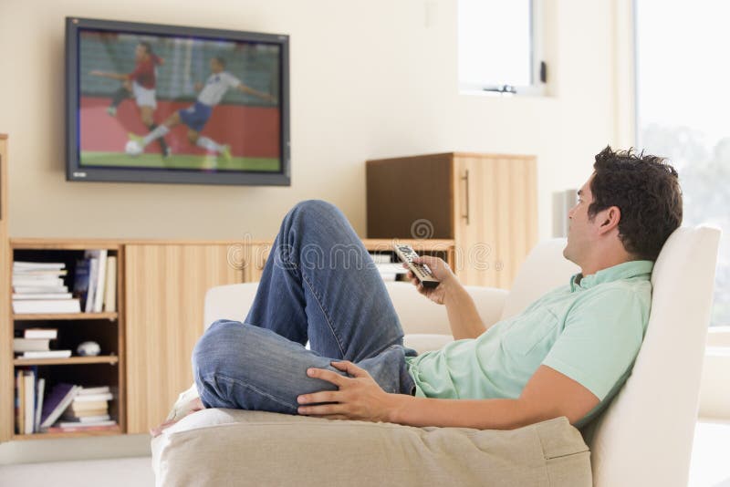 Man in living room watching television stock photo Man in living room watching television stock photo