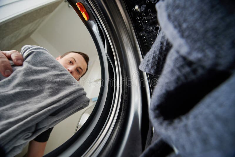 Man loading dirty cloth royalty free stock photos