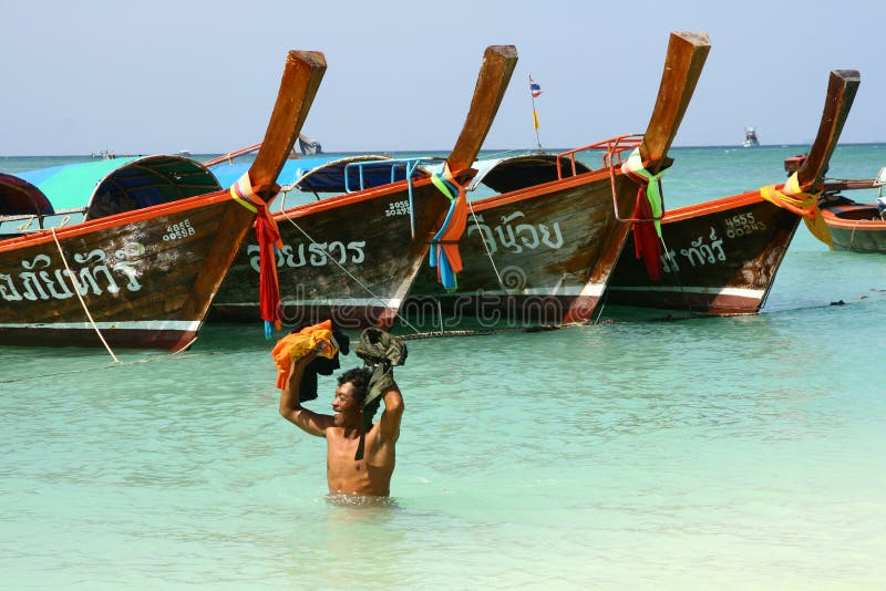 Man and long tail boats in thai island