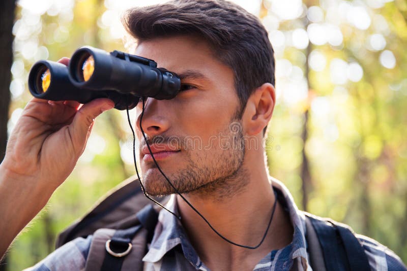 Man Looking through Binocular in the Forest Stock Photo Image of