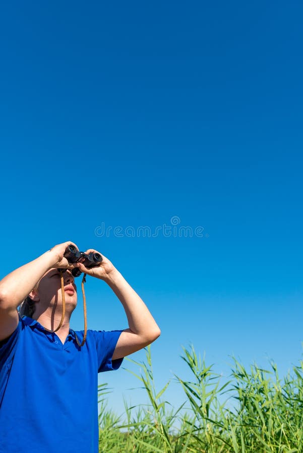 Man Looking through Binoculars into Sky Stock Photo Image of