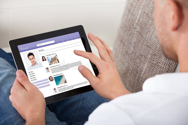 Man looking at personal profiles on a tablet royalty free stock photos Man looking at personal profiles on a tablet royalty free stock photos