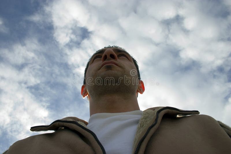 Man Looking up with the Clouds on the Background