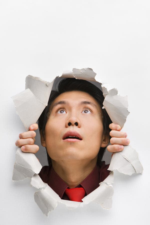 Man Looking Up Surprisingly from Hole in Wall Stock Image - Image of