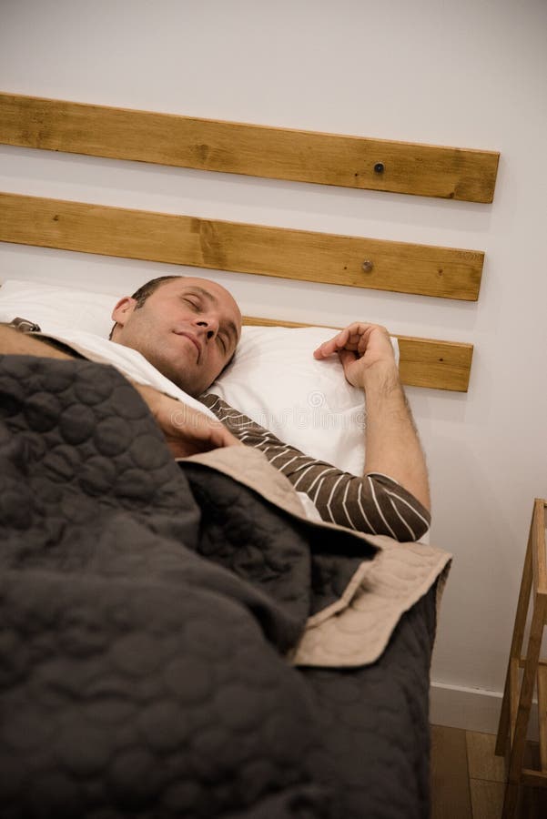 Man Lying in a Bed and Sleeping Under the Covers Stock Photo Image of