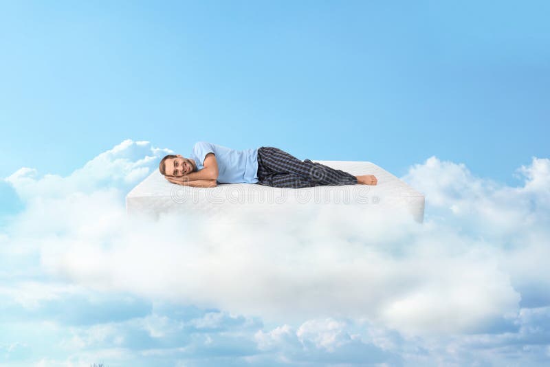 Man lying on mattress in clouds royalty free stock photo Man lying on mattress in clouds royalty free stock photo
