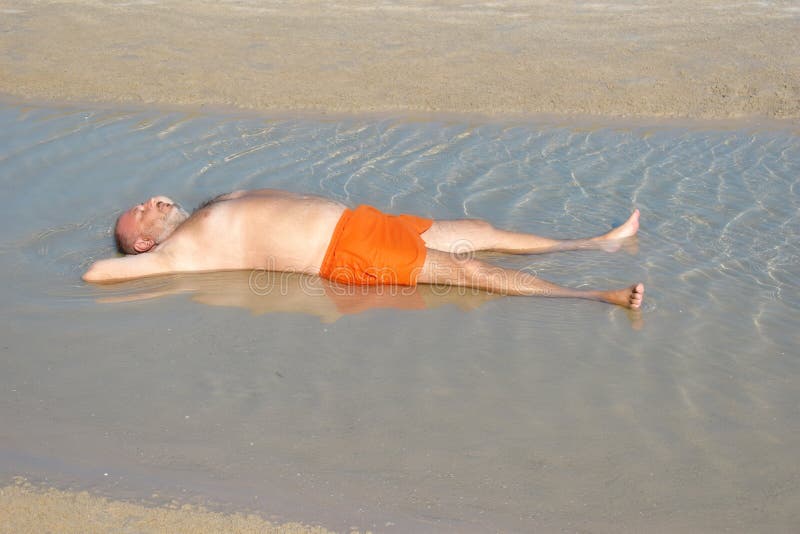 The Man in the Puddle on the Beach. Relaxing Holiday by the Sea. Fun Beach  Photo. the Fat Man in the Sea Stock Image - Image of dirt, beach: 171809049