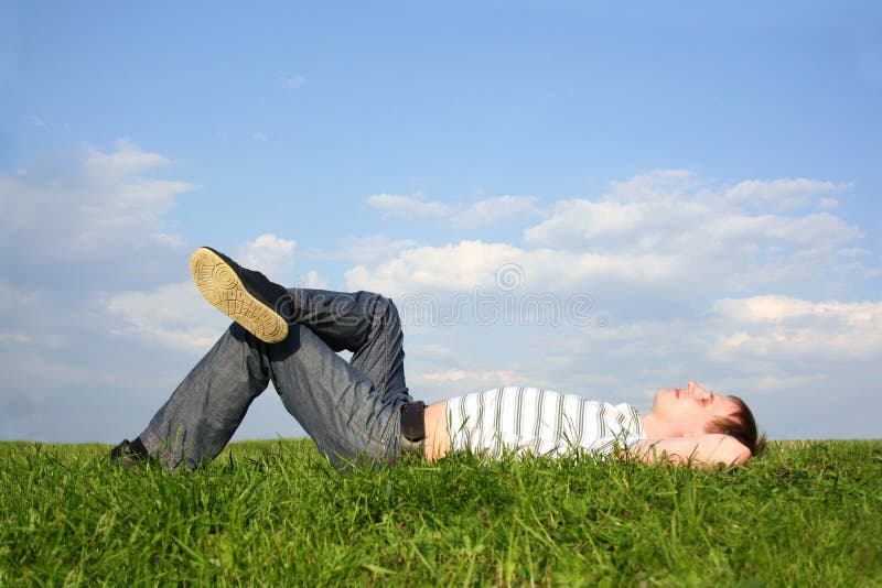 Man lying on summer lawn with closed eyes