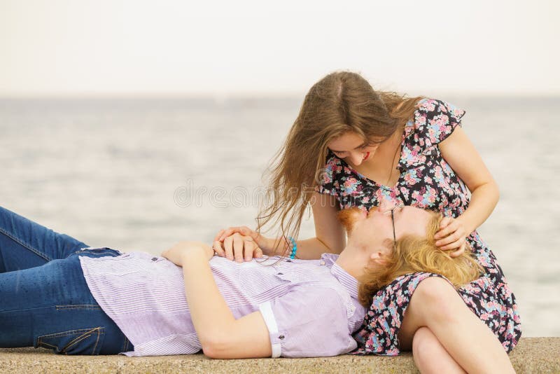 Man and woman having romantic date by beach stock photos
