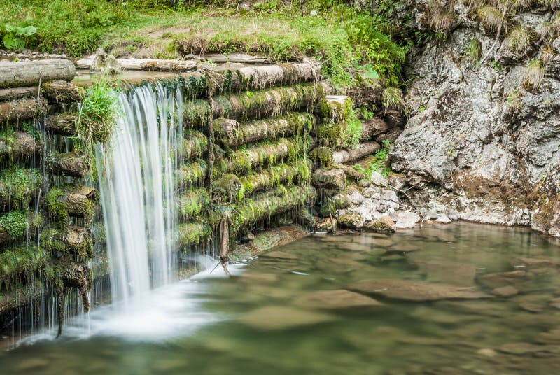 Creek and man made waterfall in the forest. Man made waterfall stock images, royalty-free photos and pictures