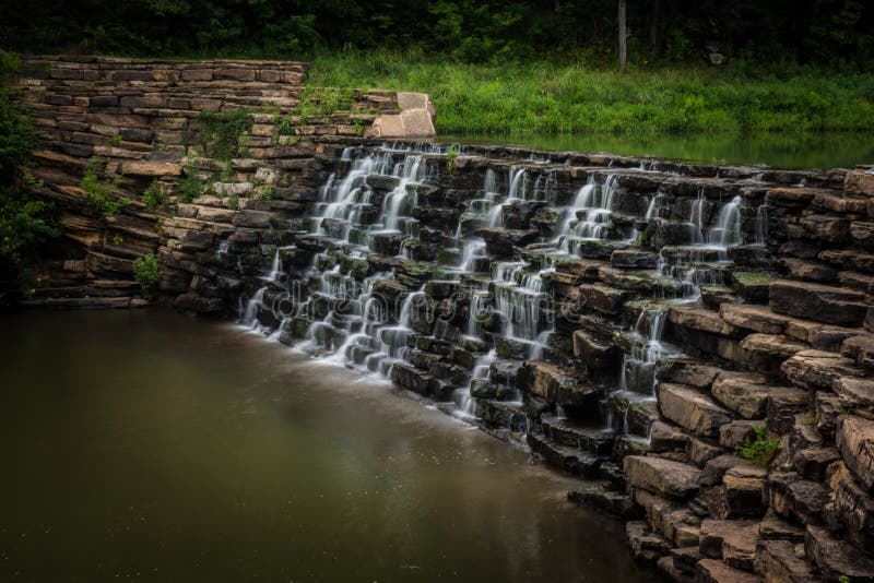 Image of water flowing over a man made waterfall. Man made waterfall stock images, royalty-free photos and pictures