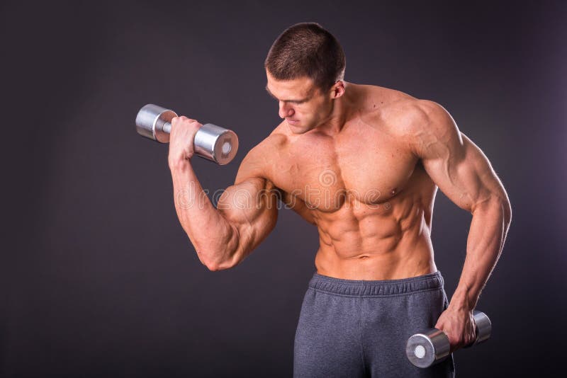 Man makes exercises dumbbells. Sport, power, dumbbells, tension, exercise. Article about fitness and sports.Gym and fitness concept - bodybuilder and dumbbell royalty free stock image Man makes exercises dumbbells. Sport, power, dumbbells, tension, exercise. Article about fitness and sports.Gym and fitness concept - bodybuilder and dumbbell royalty free stock image