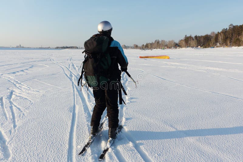 Man Man Lifting a Kite from the Snowy Surface of a Reservoir, Novosibirsk, Russia Stock Image