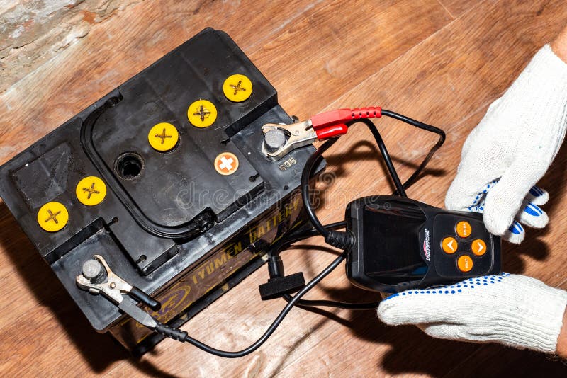 A Man Measures the Capacity and Current of a Car Battery with a