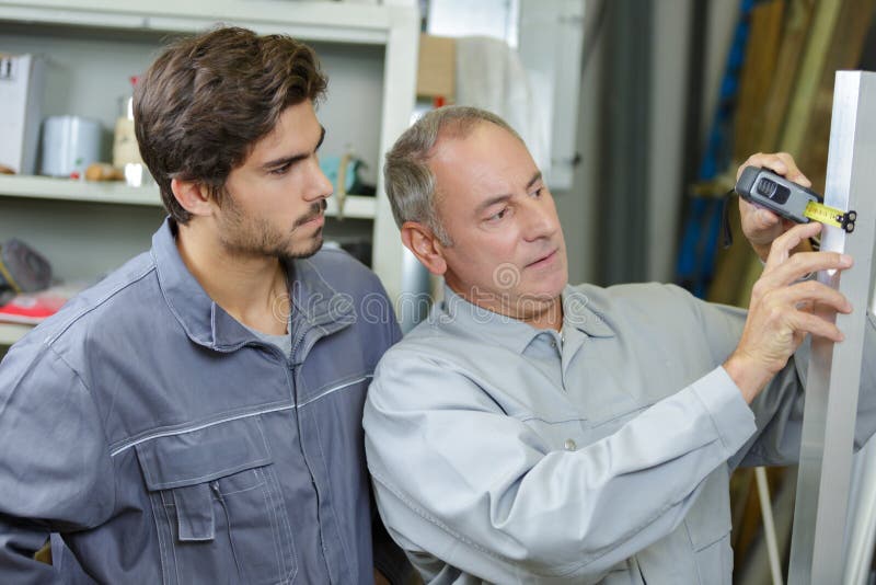Man measuring width building materials stock photo Man measuring width building materials stock photo