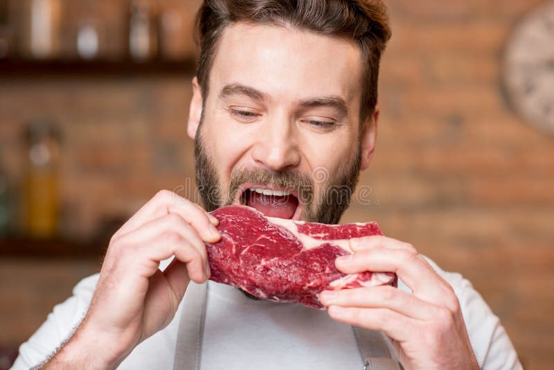 Man with meat stock photo. Image of organic, meat, biting 85077476