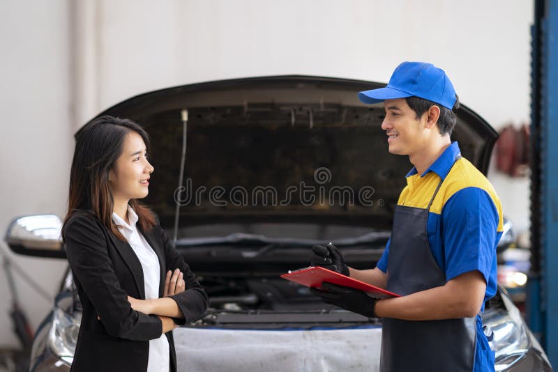 A Man Mechanic And Woman Customer Discussing Repairs