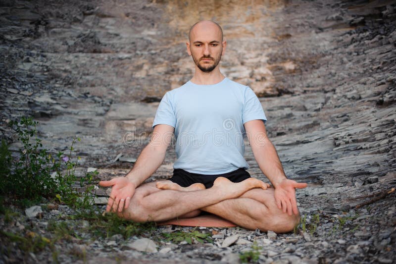 Man Meditating in the Mountain in the Morning. Doing Yoga Outdoors on ...