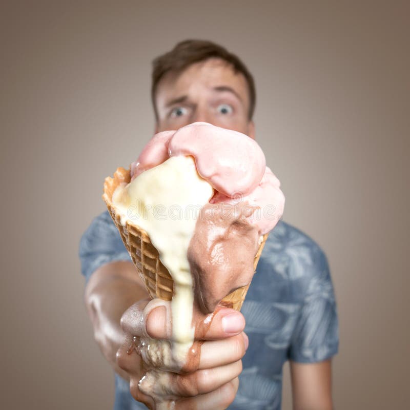 Man with a melting ice cream cone in his hand