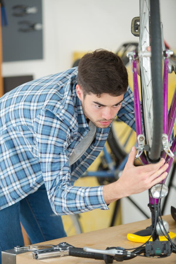 Man mending brakes stock image. Image of bicycling, tighten 268743923