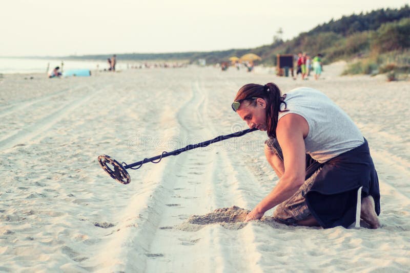 Man with Metal Detector on the Beach Stock Photo Image of