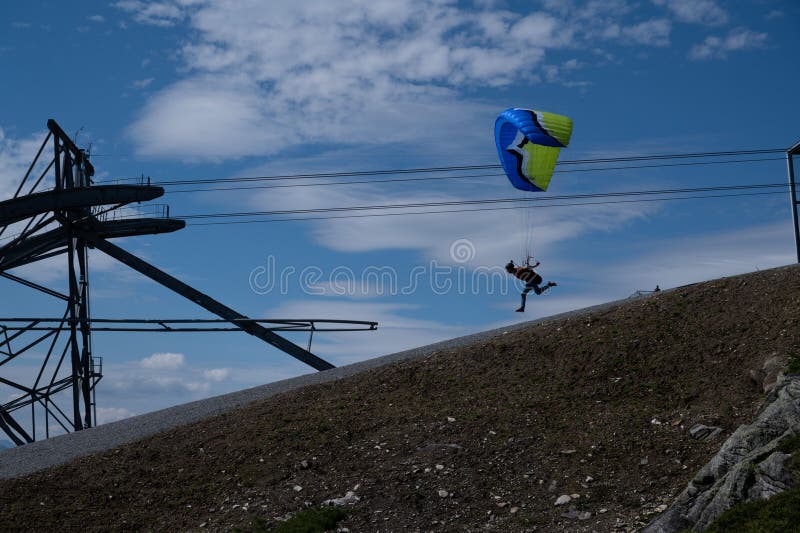 Man in Midair, Gliding Gently through the Sky, with a Parachute Stock