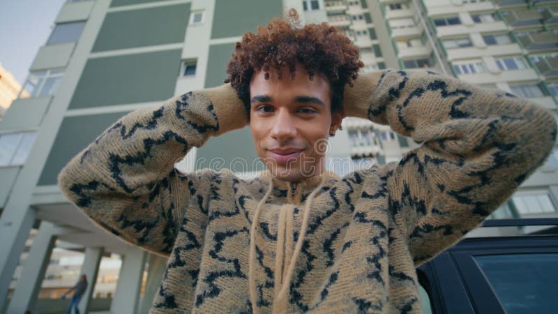 Man model standing street leaning on luxury auto closeup. Smiling latino guy stock video footage