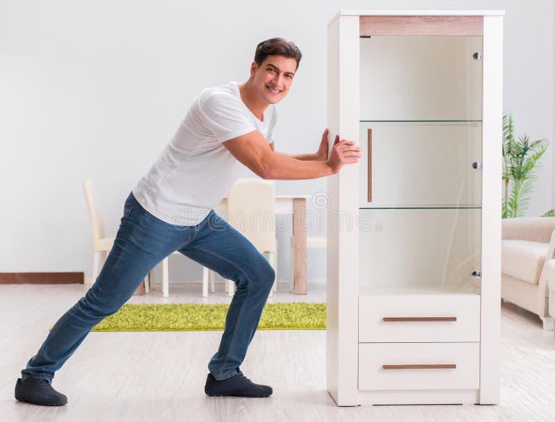 Man Moving Furniture at Home Stock Photo Image of indoor, lifting