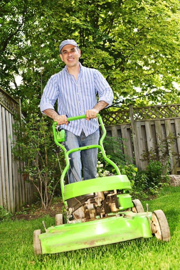 Man mowing lawn stock image