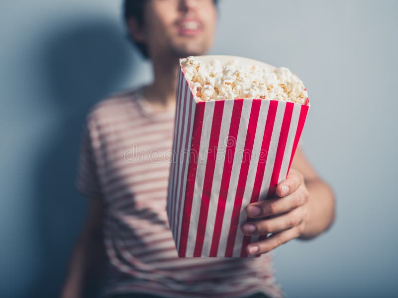 man-offering-popcorn-young-57164772.jpg