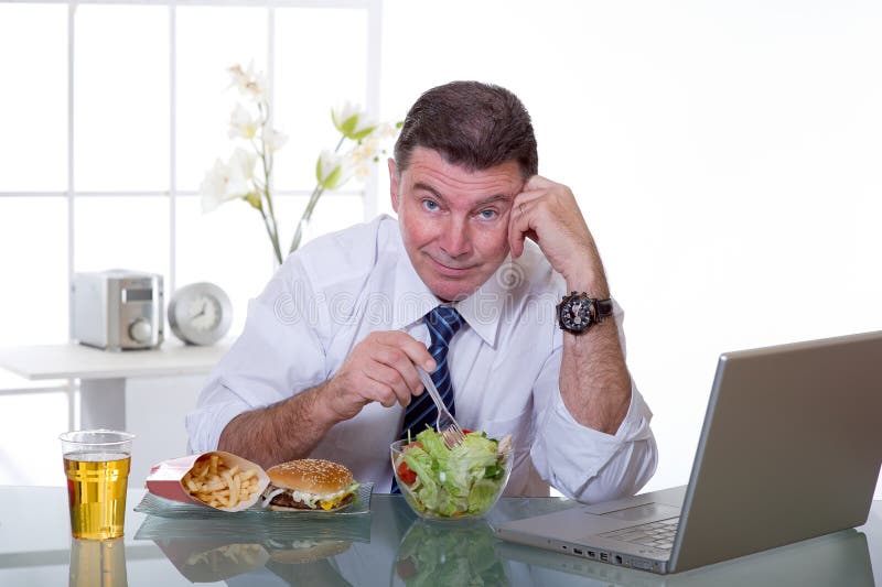 Man at office eat green salad healty food