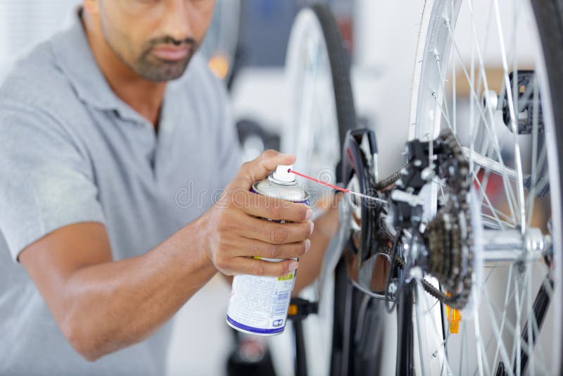 Man Oiling Bicycle Chain and Gear with Oil Spray Stock Photo Image of circuit, bike 221049828