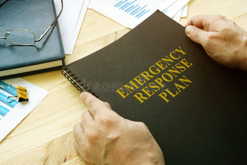 Man opens disaster and emergency response plan for reading royalty free stock photo