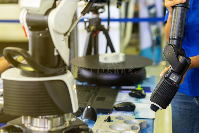 Man or operator holding head of high technology and modern automatic 3d laser scan for measuring or reverse engineering industrial manufacture.