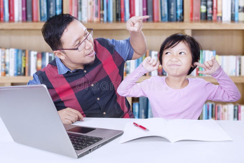 Man ordering a child to study royalty free stock photo