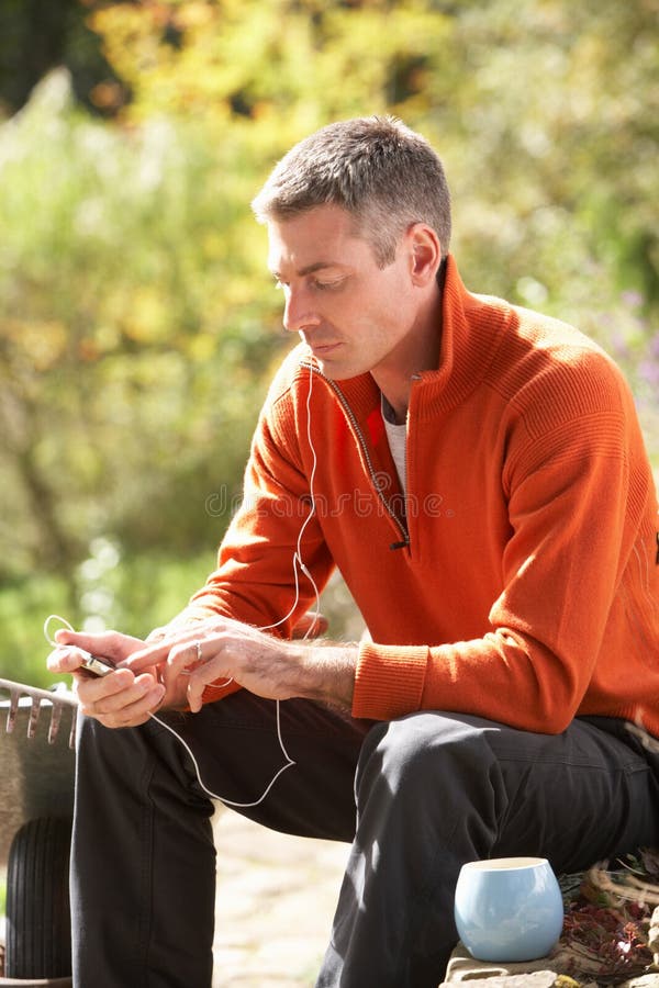 Man Outdoors Listening To MP3 Player