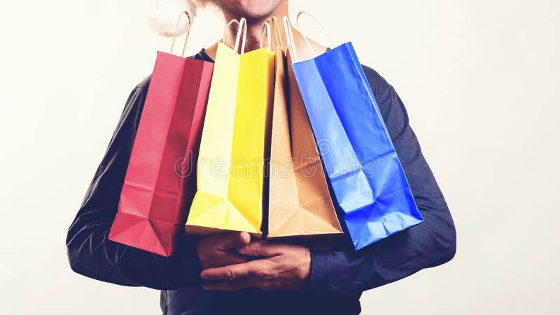 Man with packing bags. Seasonal sales. Black friday concept. Guy holds many shopping bags. Great shopping time and discounts for royalty free stock images Man with packing bags. Seasonal sales. Black friday concept. Guy holds many shopping bags. Great shopping time and discounts for royalty free stock images