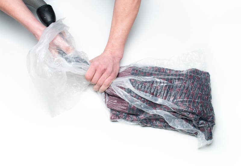 Man Packs Clothes into a Vacuum Bag Stock Photo - Image of isolated ...