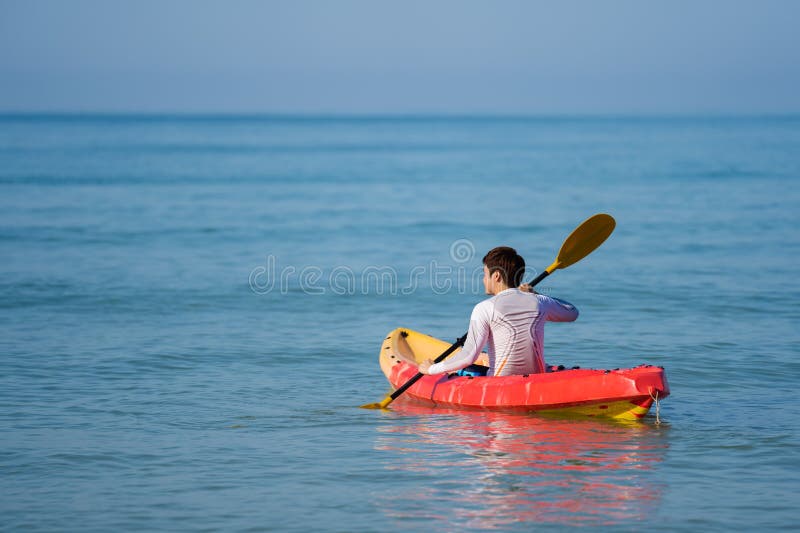 Man Paddling a Kayak Boat in Sea Stock Photo Image of outdoors, male
