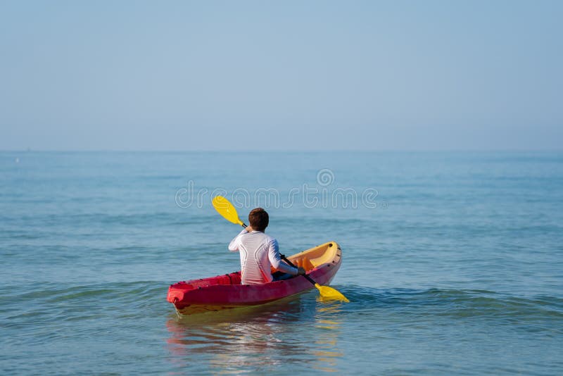 Man Paddling a Kayak Boat in Sea Stock Image Image of swimwear, nature 241896661