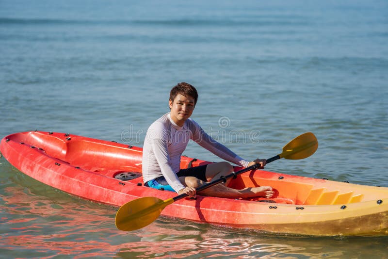Man Paddling a Kayak Boat in Sea Stock Photo Image of jacket, swimsuit 241315548