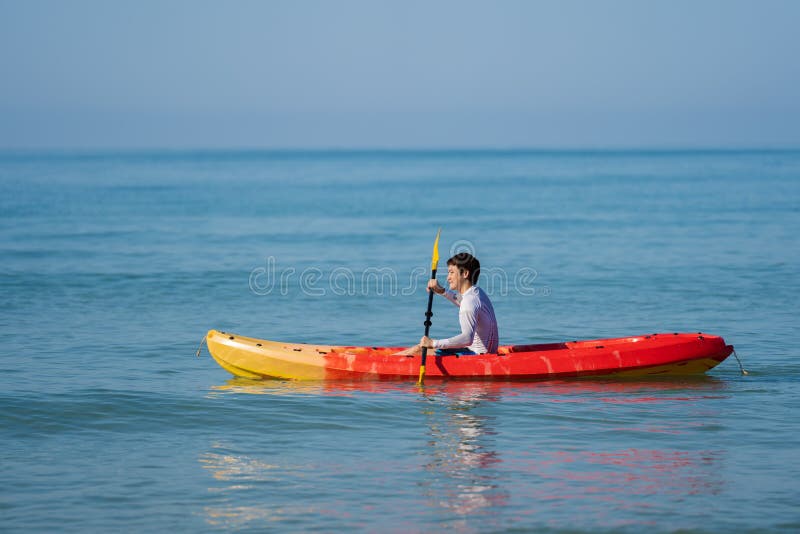 Man Paddling a Kayak Boat in Sea Stock Photo Image of swimsuit, thai
