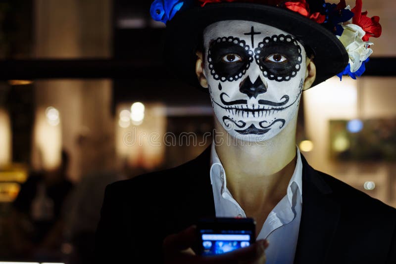 A Man with a Painted Face of a Skeleton, a Dead Zombie, in the City during the Day. Day of All Souls, Day of the Dead, Halloween, Stock Photo - Image of A Man With A Painted Face Of A Skeleton, A Dead Zombie, In The City During The Day. Day Of All Souls, Day Of The Dead, Halloween, Stock Photo - Image Of